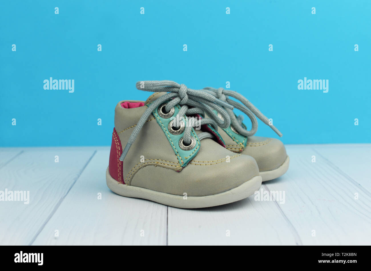 children's shoes gray boots on a blue background with white wooden advertising store Stock Photo