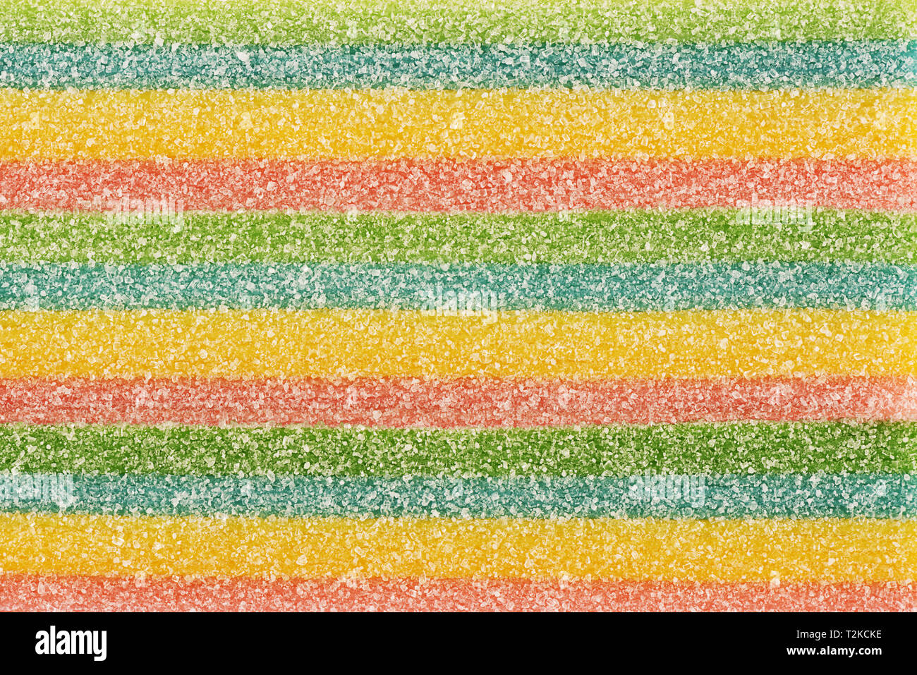 Top view on background texture and colorful licorice candy. Copy space for text. Stock Photo