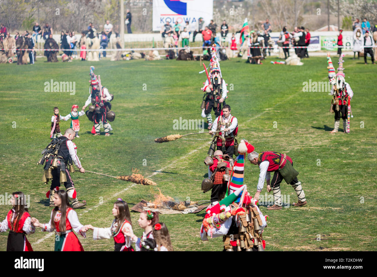 VARVARA, BULGARIA - MARCH 24, 2019: Moment from National Festival Dervish Varvara presents traditions of Bulgarian Kuker Games. Men spin burning and s Stock Photo
