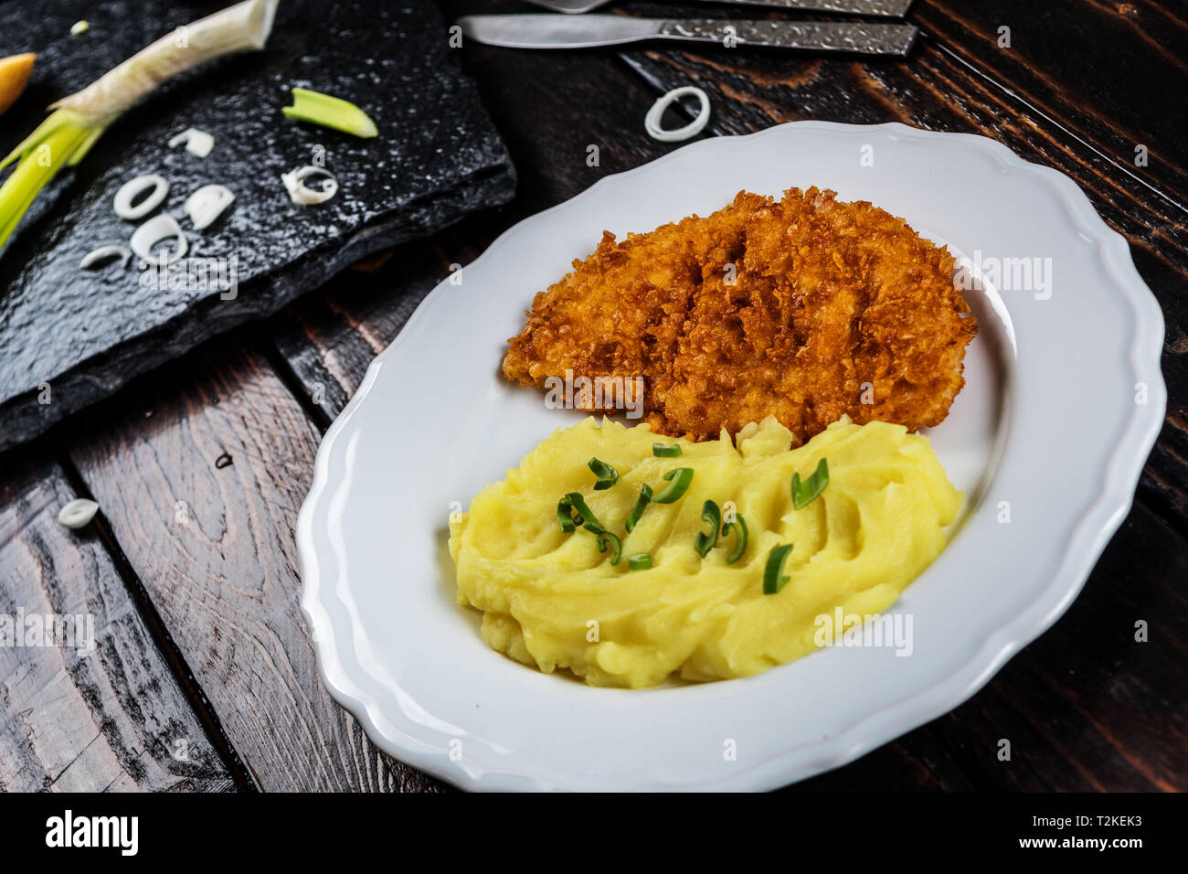 Fried chicken steak or schnitzel with mashed potatoes on wood table Stock Photo Alamy