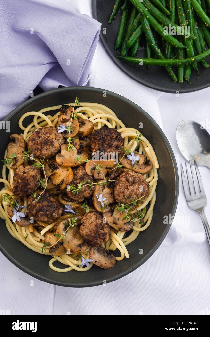 spaghetti and meatballs with mushrooms, beans and thyme leaves Stock Photo Alamy