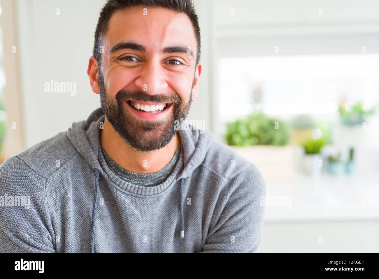 Handsome man smiling cheerful with a big smile on face showing teeth