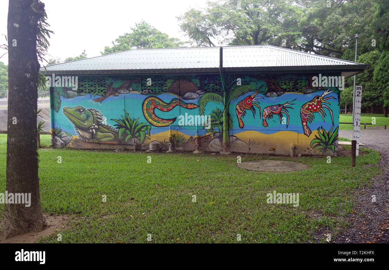 Public toilet block painted by local Indigenous artists featuring rainforest and river animals, Mossman, Queensland, Australia Stock Photo
