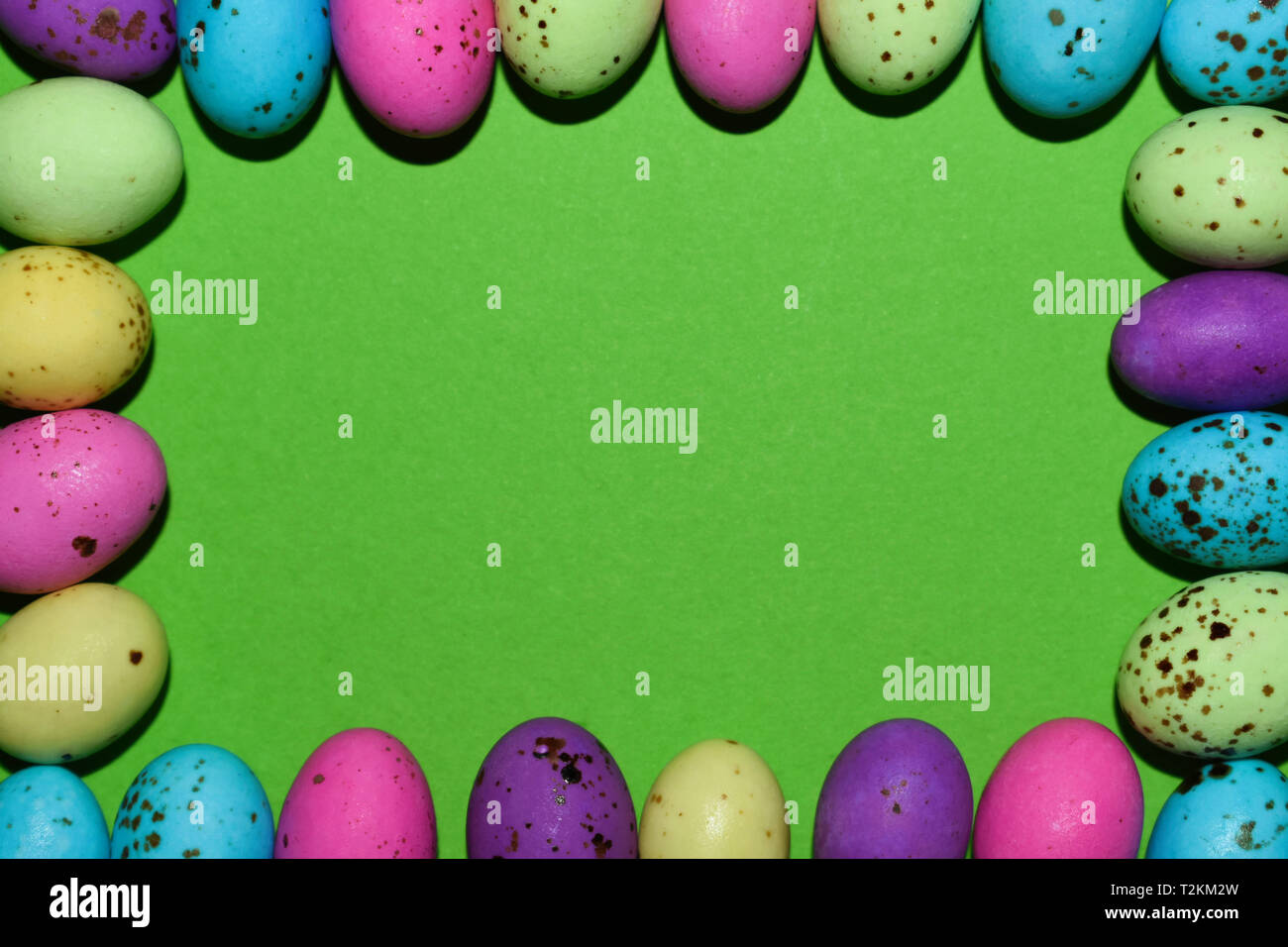 Colorful Candy Egg Frame With Green Copy Space Stock Photo