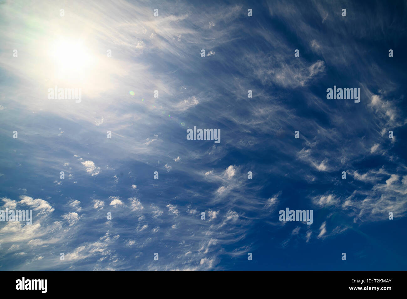 The combination of sun, blue sky, and wispy clouds make for interesting patterns. Stock Photo
