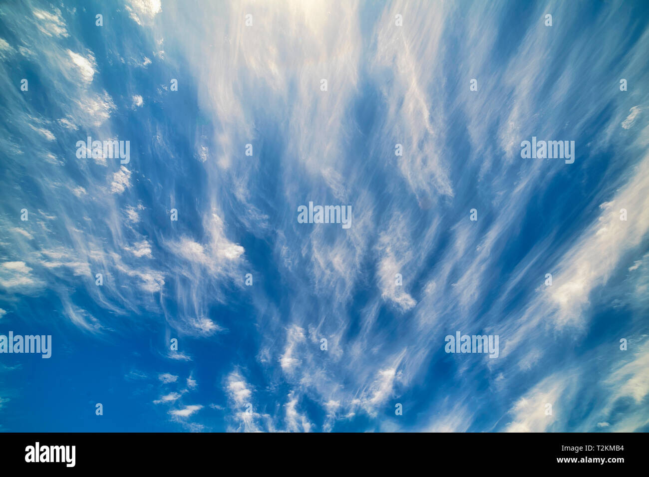 The combination of sun, blue sky, and wispy clouds make for interesting patterns. Stock Photo