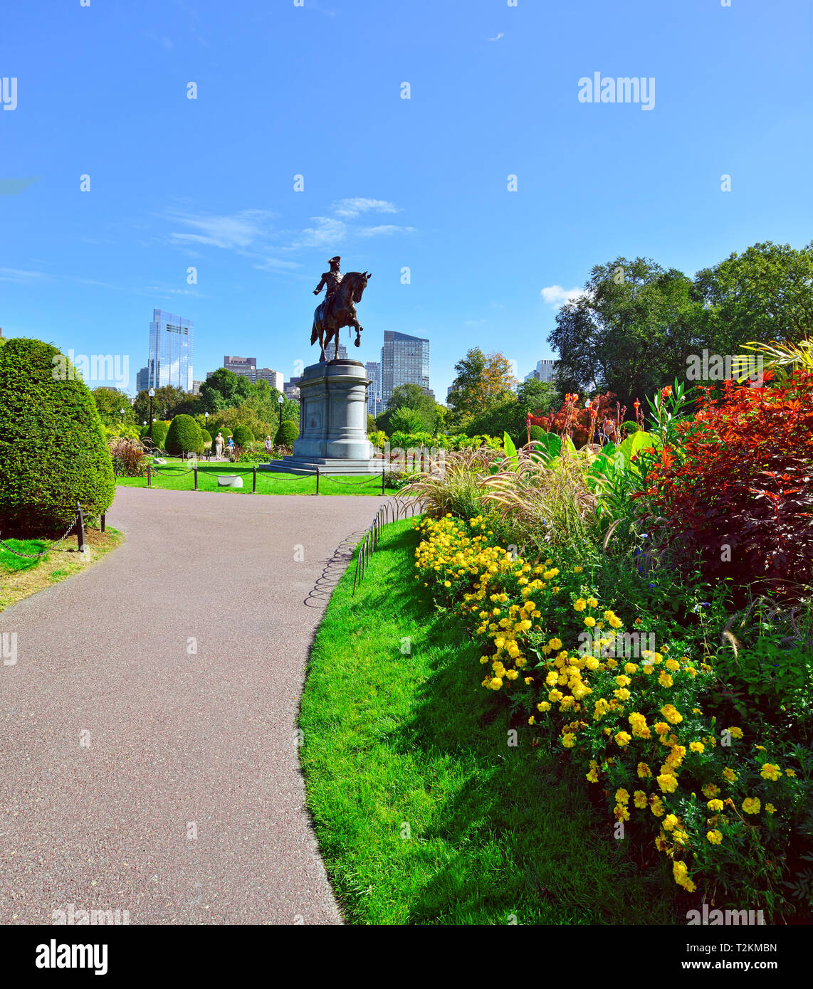 Boston Public Garden, summer and fall grounds landscaping. Washington statue and city skyline in background Stock Photo