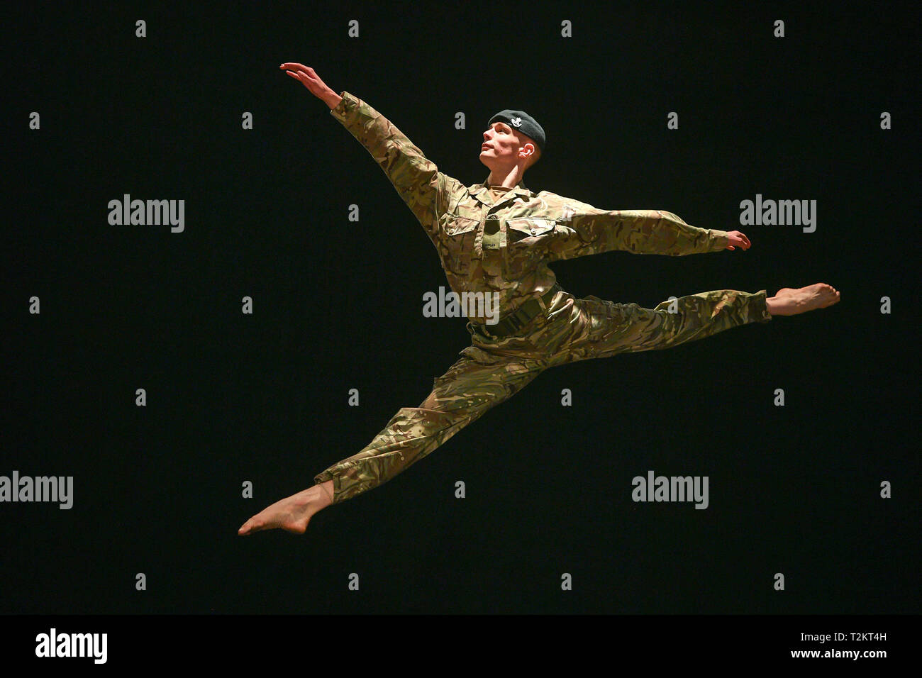 Serving soldier in the British Army, Trooper Alex Smith, 22, of 1st The Queen's Dragoon Guards, leaps into the air during rehearsals for a production called '10 Soldiers' by the Rosie Kay dance company about military life. Stock Photo