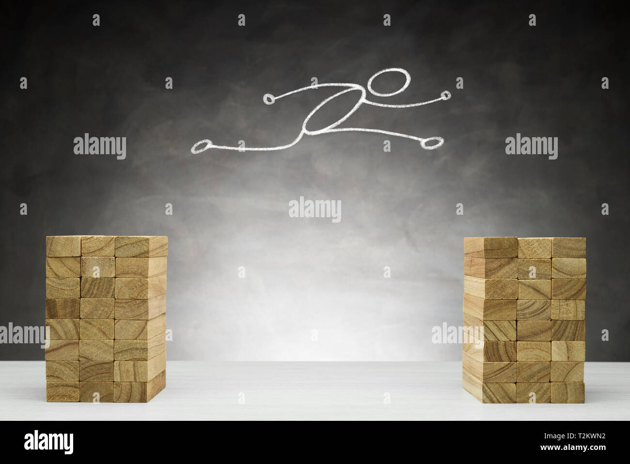 Rise and improvement concept. Human shape jumps between two blocks. Stock Photo