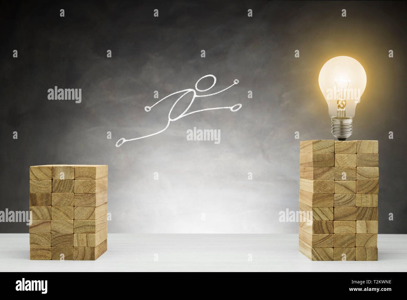 Rise and improvement concept. Human shape jumps between two blocks. Stock Photo