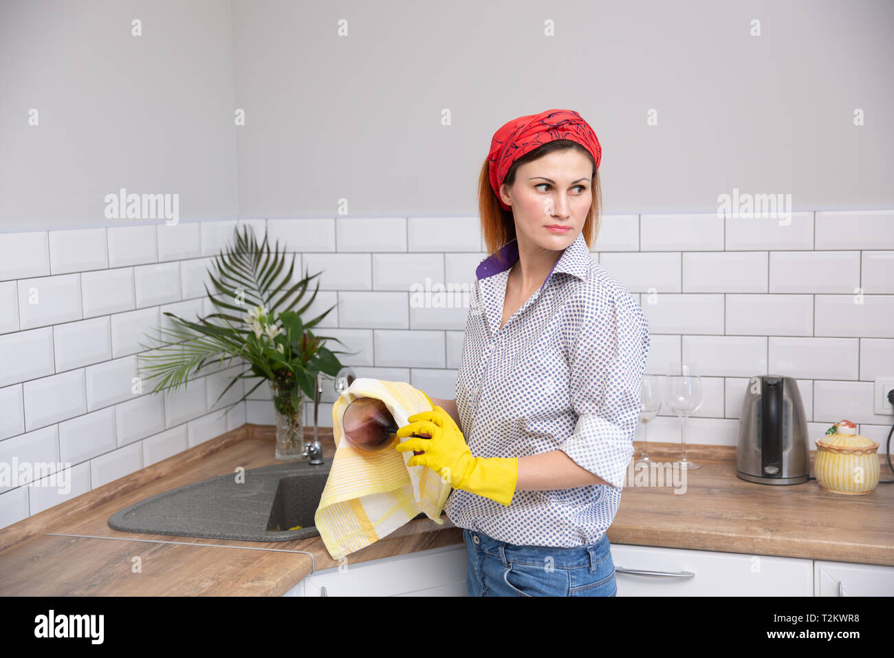 Woman cleaning or ruges glass in the kitchen. housekeeper doing spring cleaning Stock Photo