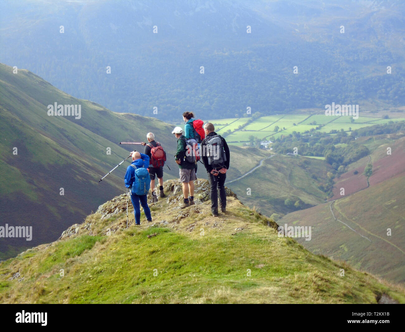 A Fellwalking Group Standing and Looking from Knott Ridge on the Wainwright  Ard Crags, Newlands Valley, Lake District National Park, Cumbria, UK. Stock Photo