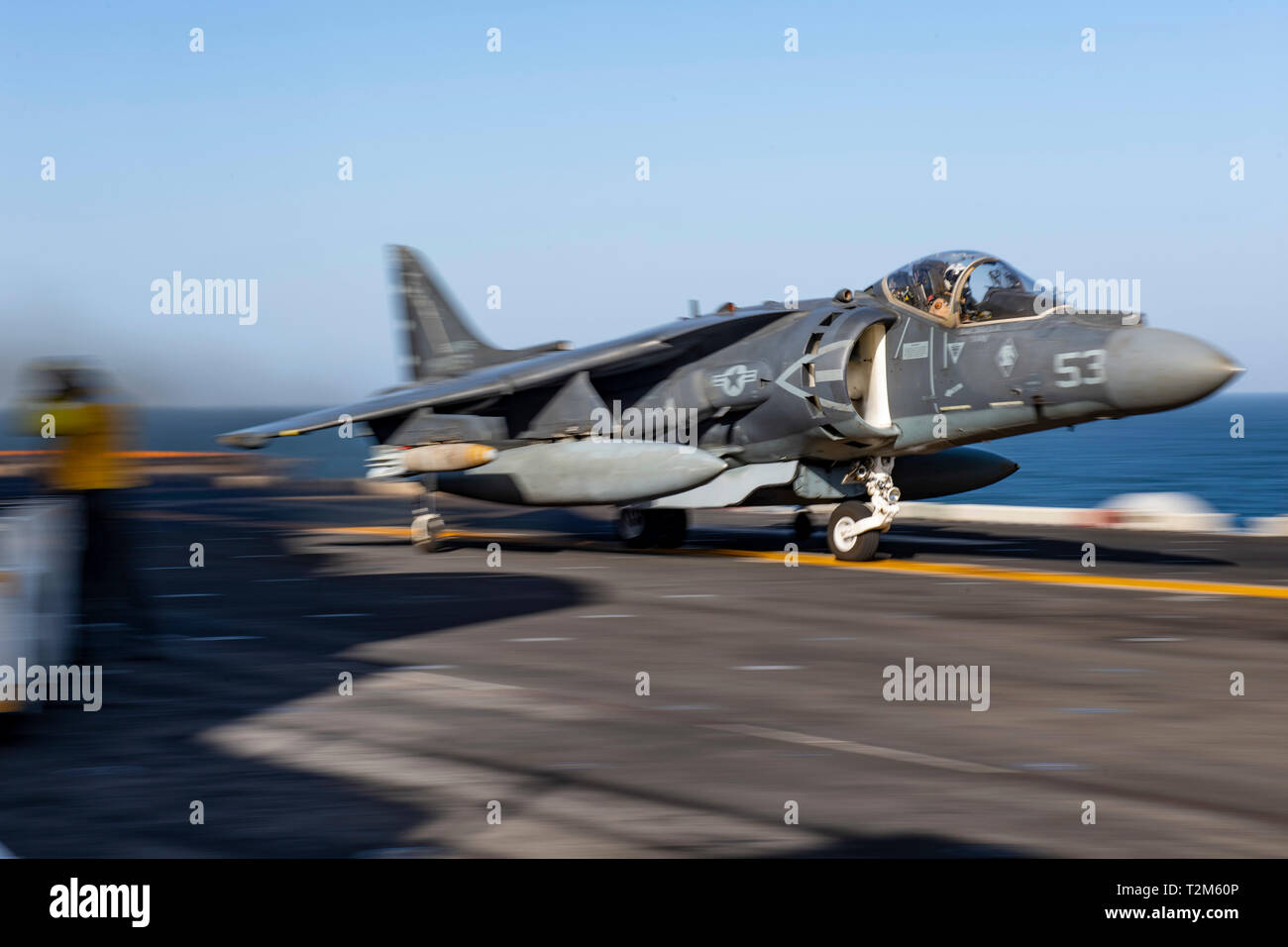 A U.S. Marine Corps AV-8B Harrier launches from the flight deck of the Wasp-class amphibious assault ship USS Kearsarge (LHD 3) in the 5th Fleet area of operations, April 1, 2019. Kearsarge is the flagship for the Kearsarge Amphibious Ready Group and, with the embarked 22nd Marine Expeditionary Unit, is deployed to the U.S. 5th Fleet area of operations in support of naval operations to ensure maritime stability and security in the Central region, connecting the Mediterranean and the Pacific through the western Indian Ocean and three strategic choke points. (U.S. Navy photo by Mass Communicatio Stock Photo