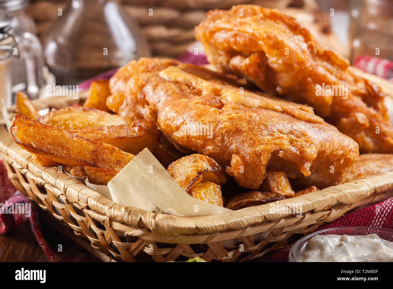 Traditional fish in beer batter and chips served on basket Stock Photo -  Alamy