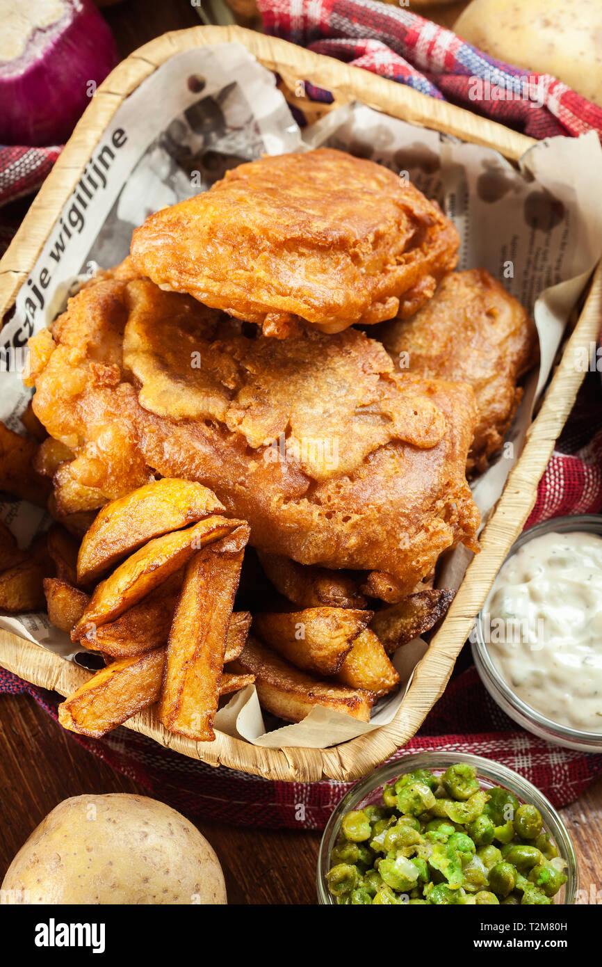 Traditional fish in beer batter and chips served on basket. Top view Stock Photo