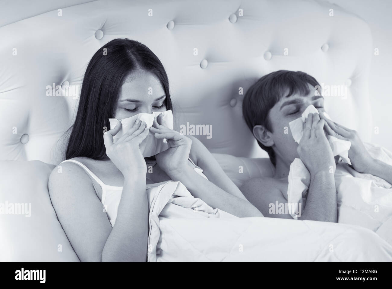 couple in bed suffering common cold Stock Photo