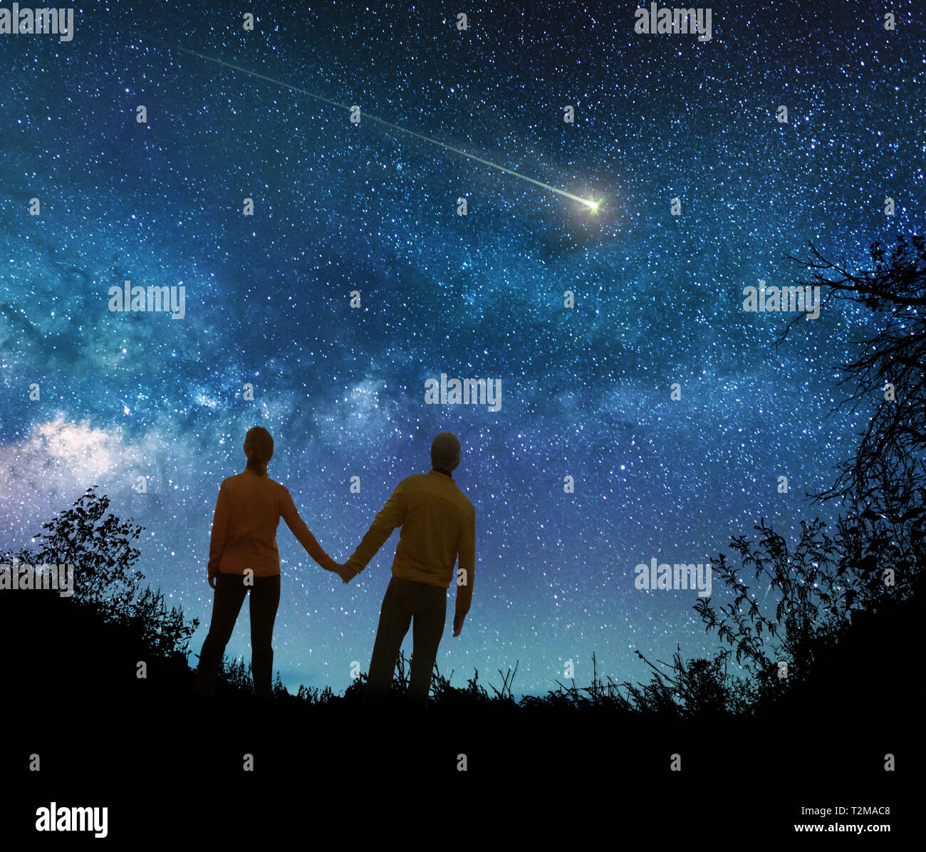Couple in love watching the stars in night sky Stock Photo