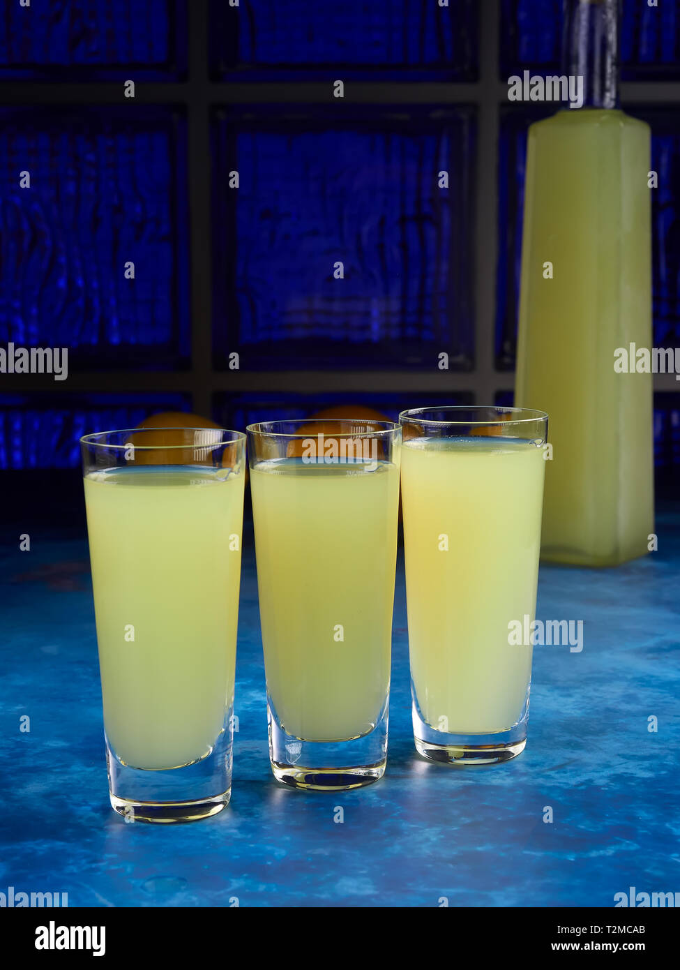 Three glasses of traditional Italian liqueur limoncello or limoncino