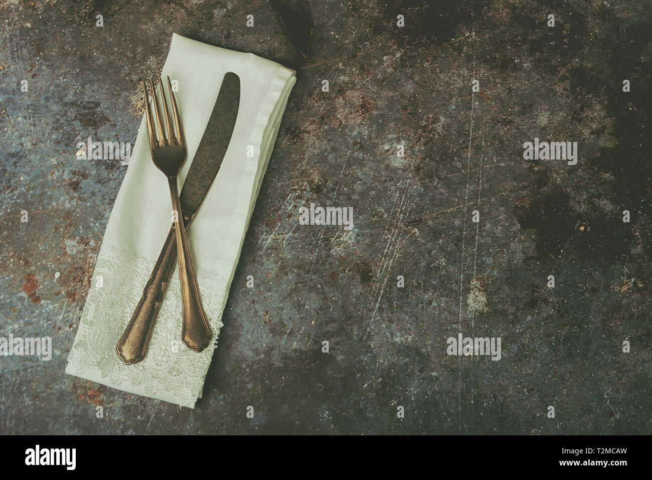 Vintage cutlery and napkin on Grunge background Stock Photo