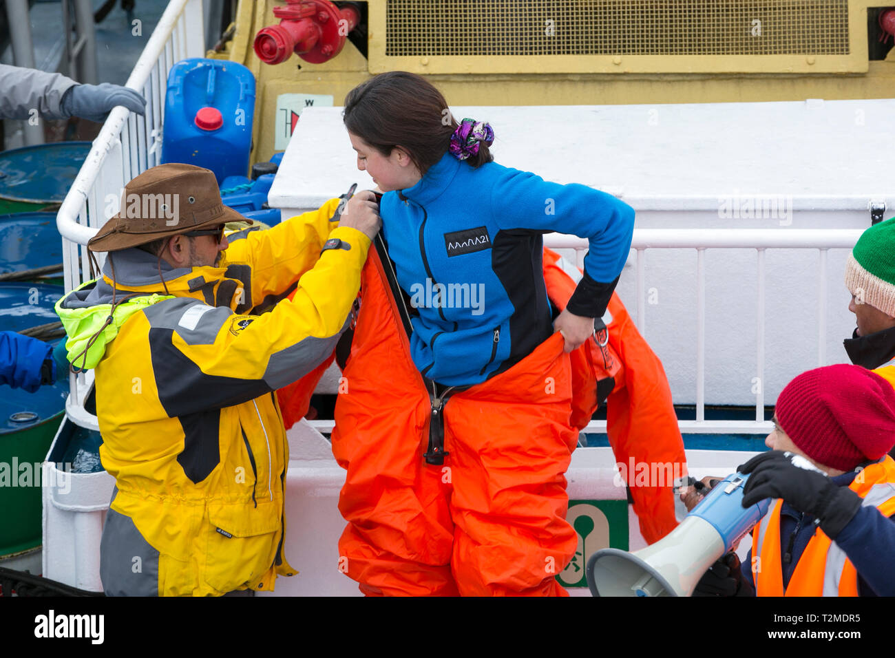 Crew And Passengers Go Through A Safety Drill On An Antarctic Cruise Ship With The Crew Showing How To Fit A Survival Suit Designed To Keep You Alive Stock Photo Alamy