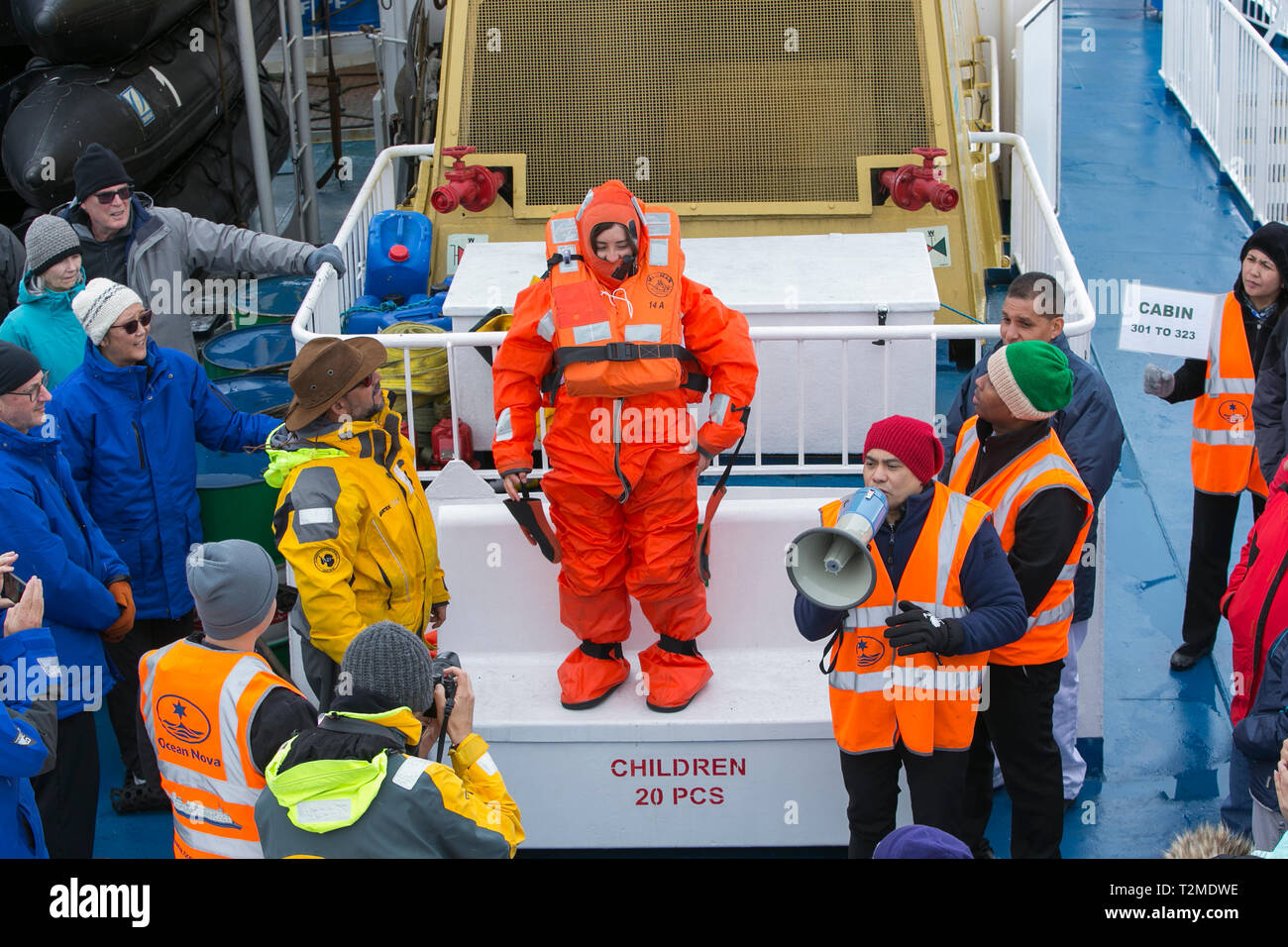 Crew And Passengers Go Through A Safety Drill On An Antarctic Cruise Ship With The Crew Showing How To Fit A Survival Suit Designed To Keep You Alive Stock Photo Alamy