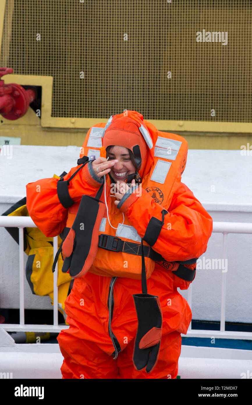 Crew and passengers go through a safety drill on an Antarctic cruise