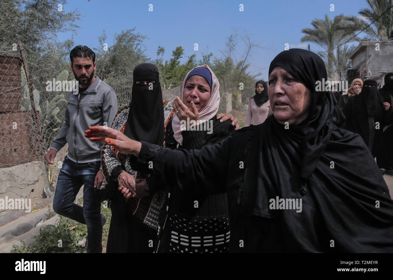 Relatives of the deceased are seen mourning during the funeral ceremony of Faris Abu Hijras, 26, who was killed by Israeli troops east of Khuza'a near the Israeli-Gaza border during the Palestinian Land Day demonstrations. Stock Photo