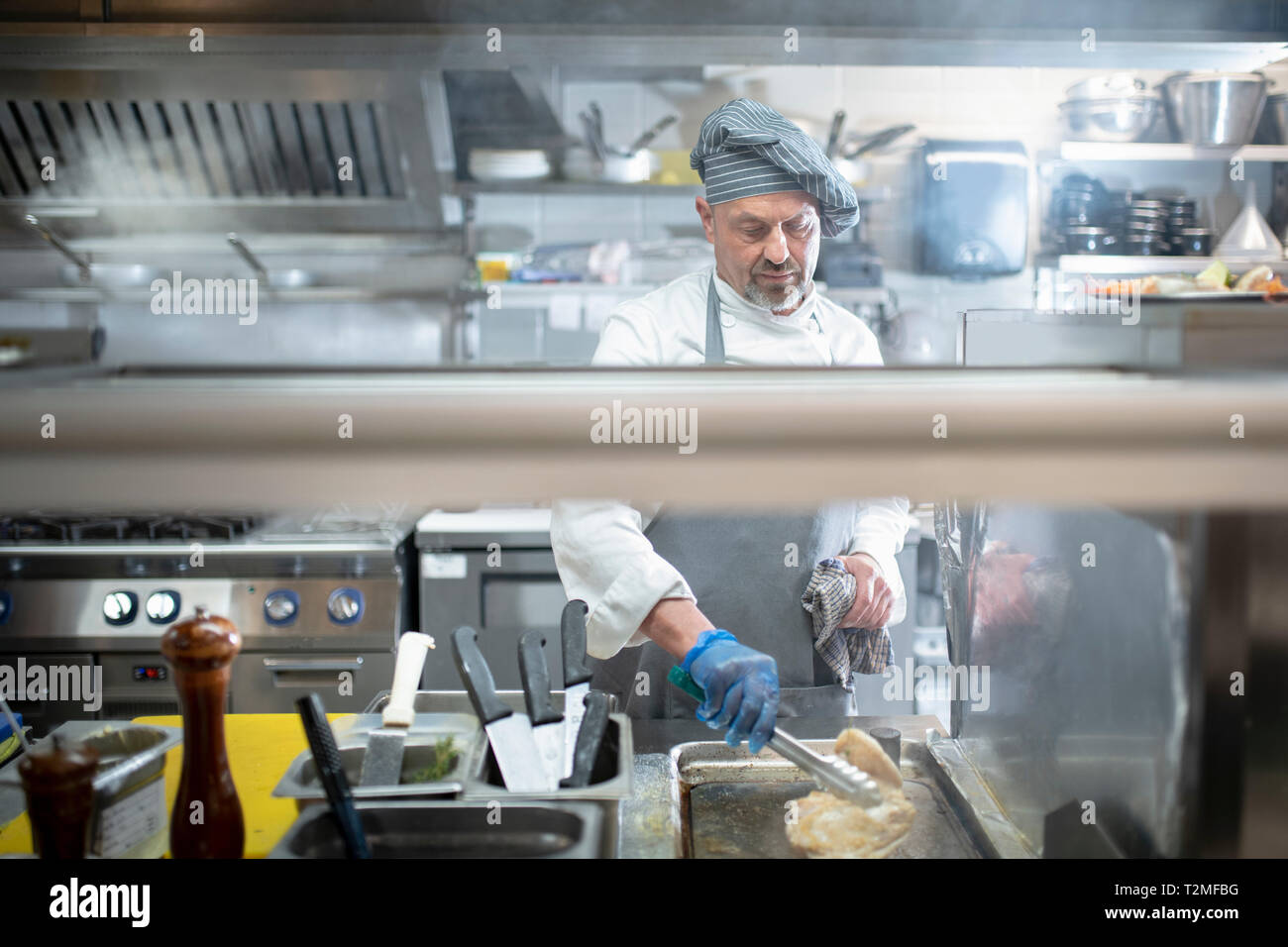 Chef cooking in Italian restaurant kitchen Stock Photo