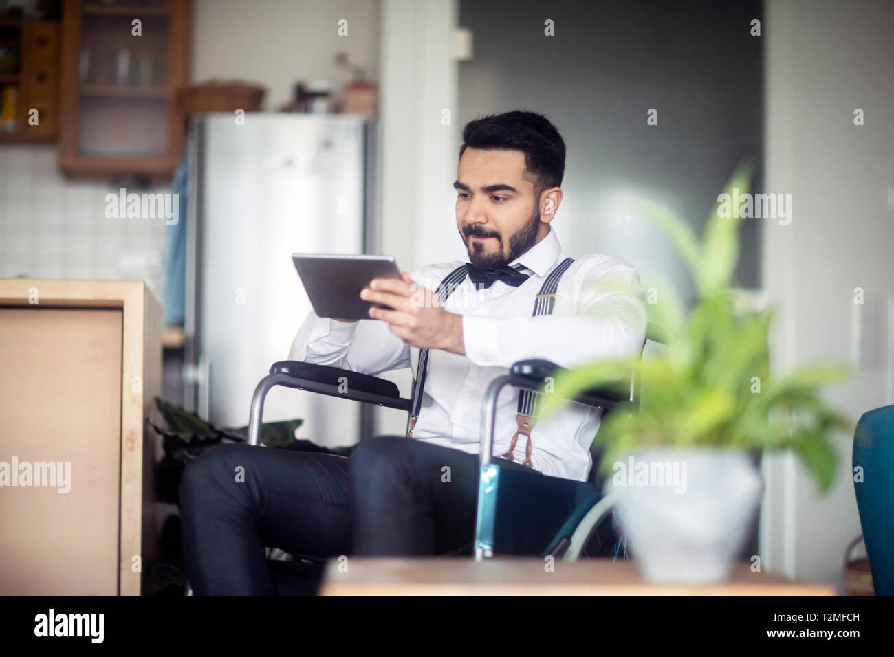 Businessman using digital tablet in wheelchair Stock Photo