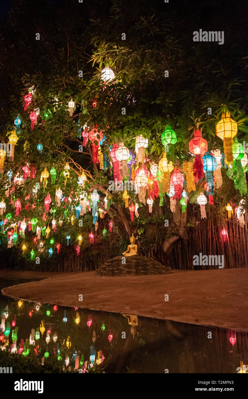 Buddha statue surround by colourful lanterns Stock Photo