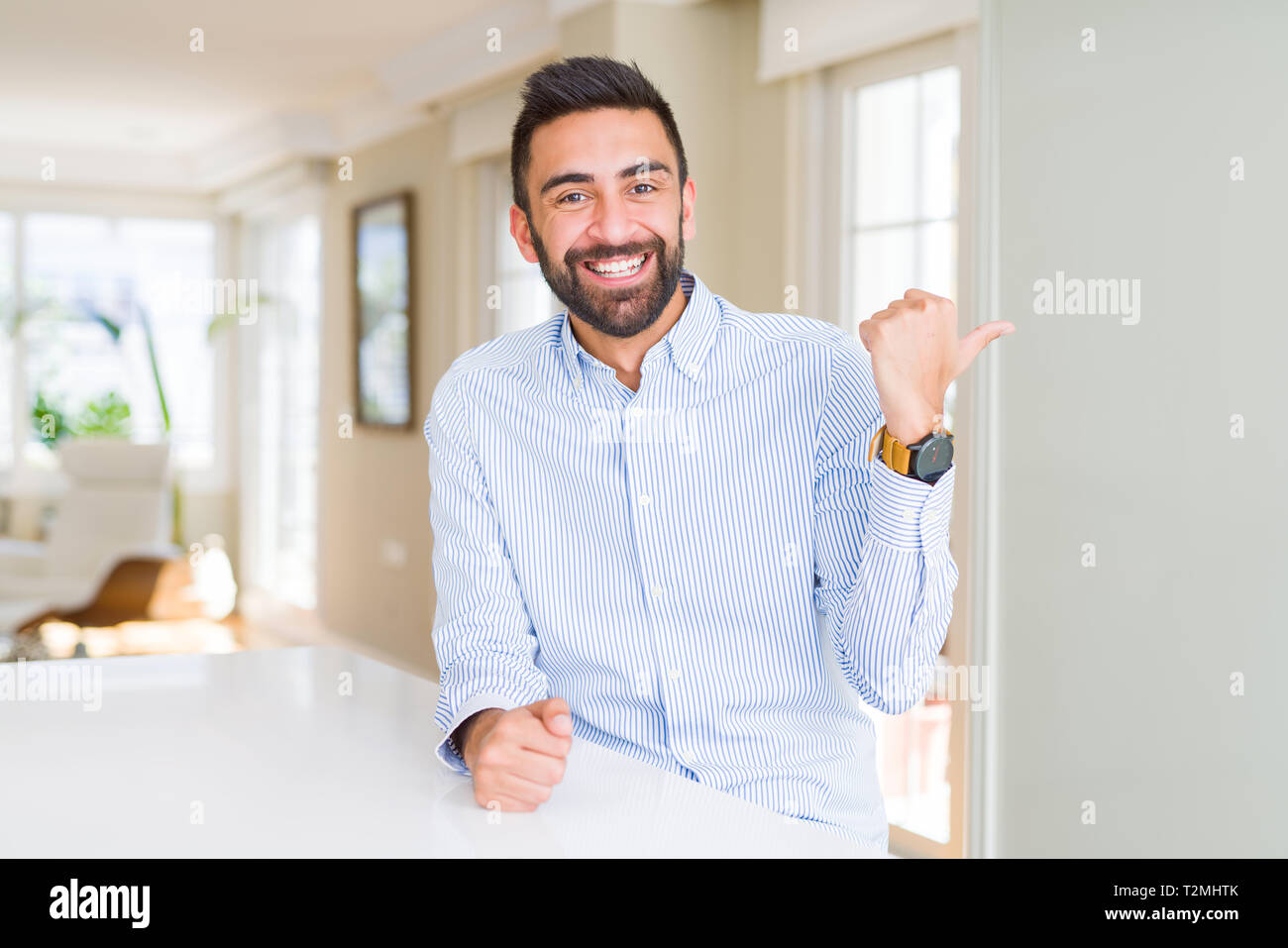 Handsome hispanic business man smiling with happy face looking and ...
