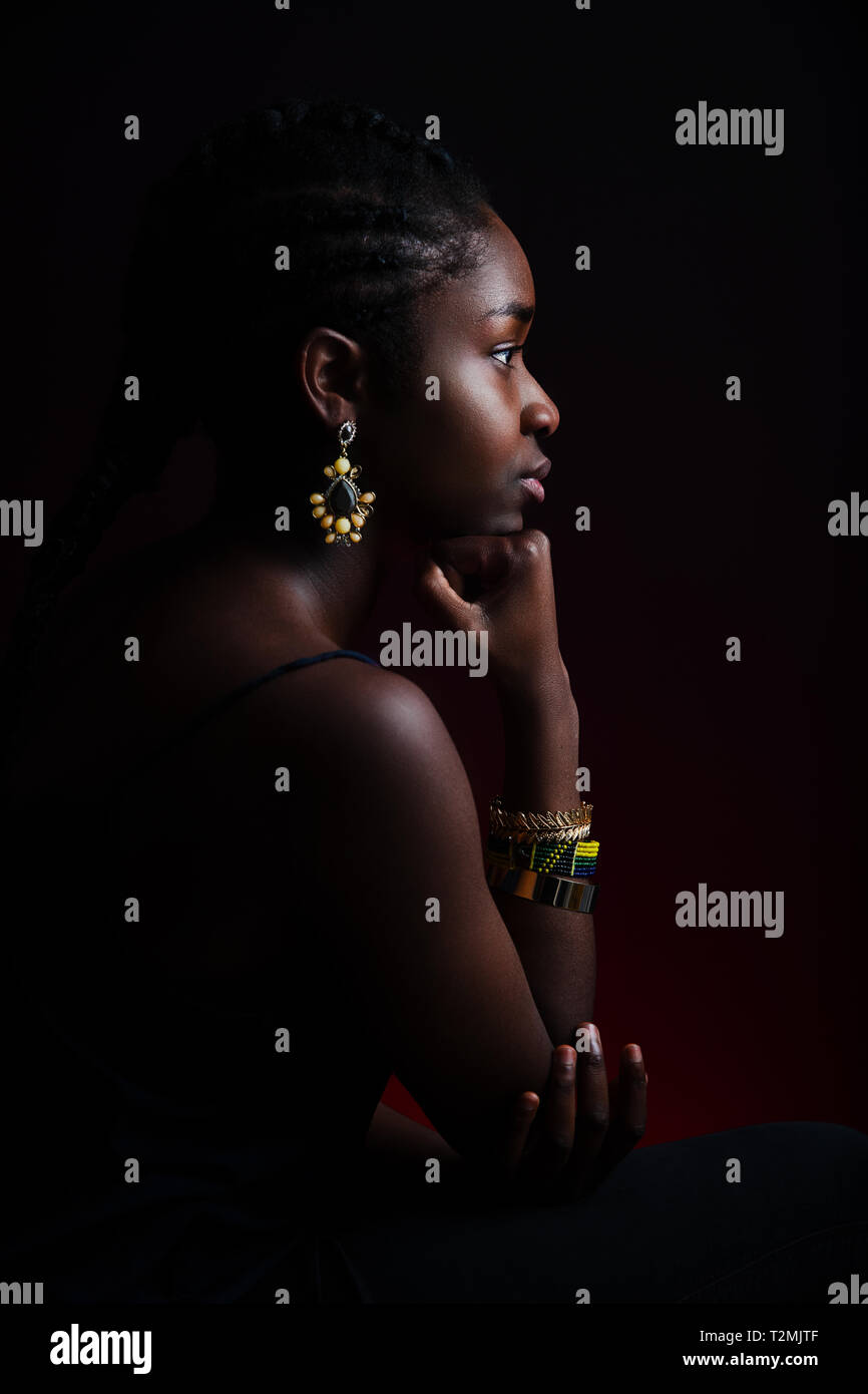 Colorful And Dark Side View Portrait Of Native African Woman With
