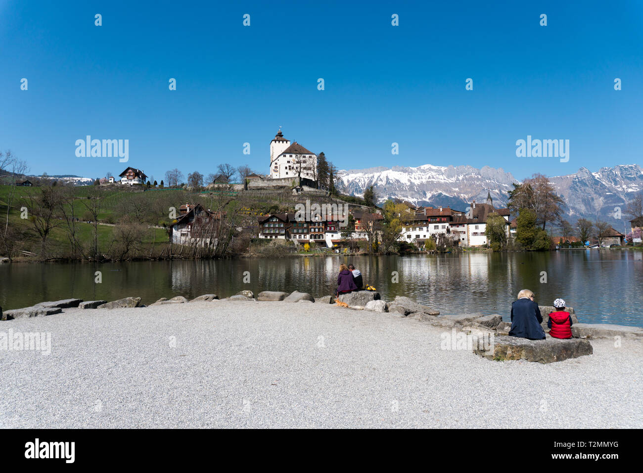 Werdenberg, SG / Switzerland - March 31, 2019: tourists enjoy a visit to idyllic and historic Werdenberg village and lake with a great view of the Swi Stock Photo