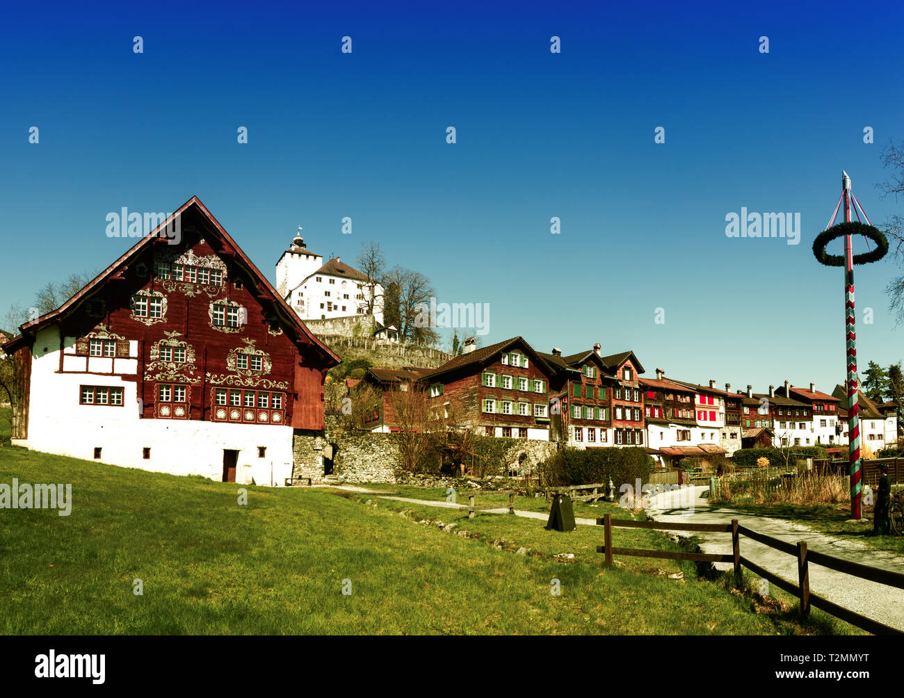 Werdenberg, SG / Switzerland - March 31, 2019: historic Werdenberg village and castle with traditional Burgher homes with wall art and painting Stock Photo