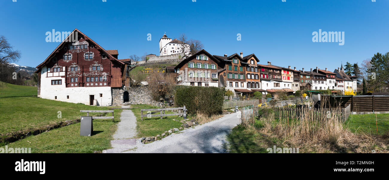 Werdenberg, SG / Switzerland - March 31, 2019: historic Werdenberg village and castle with traditional Burgher homes with wall art and painting Stock Photo