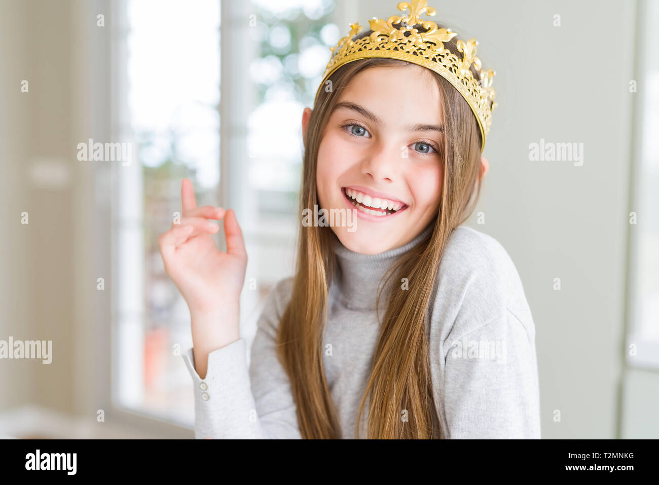 Beautiful young girl wearing a golden crown as a princess from ...