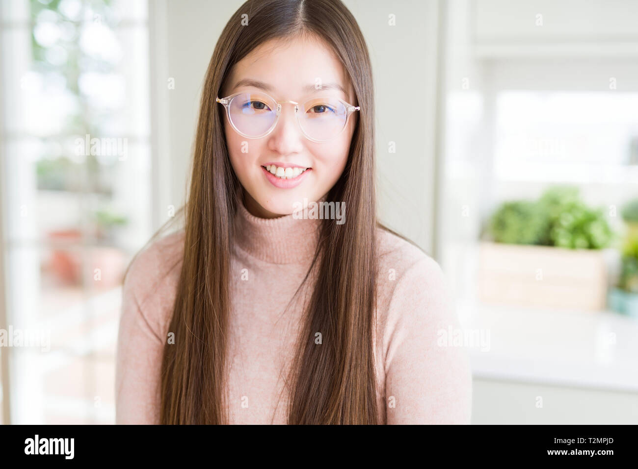 Beautiful Asian woman wearing glasses with a happy and cool smile on face.  Lucky person Stock Photo - Alamy