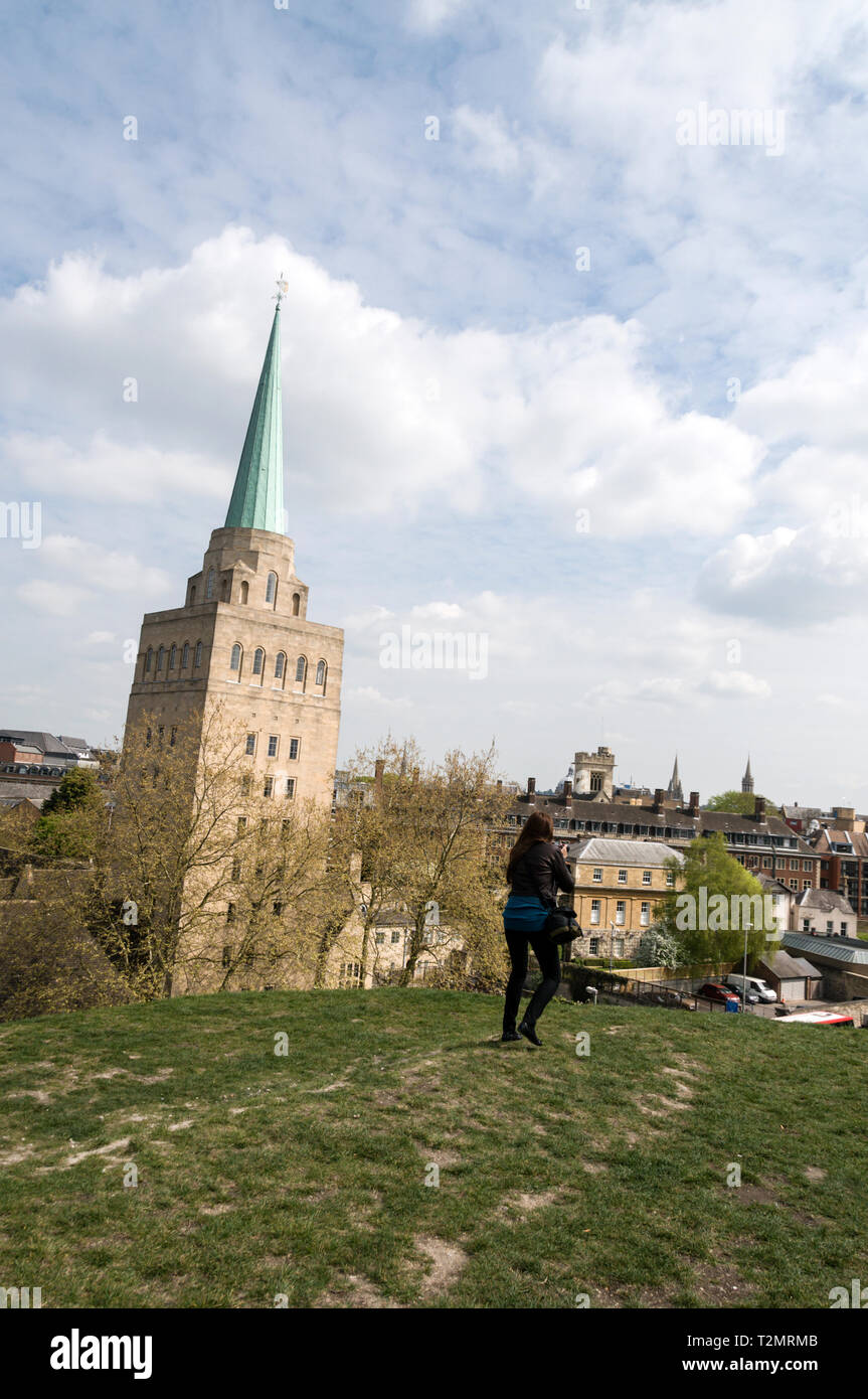 A young tourist taking a photograph of the skyline near the chapel spire of Nuffield College in New Road, Oxford,Britain Stock Photo