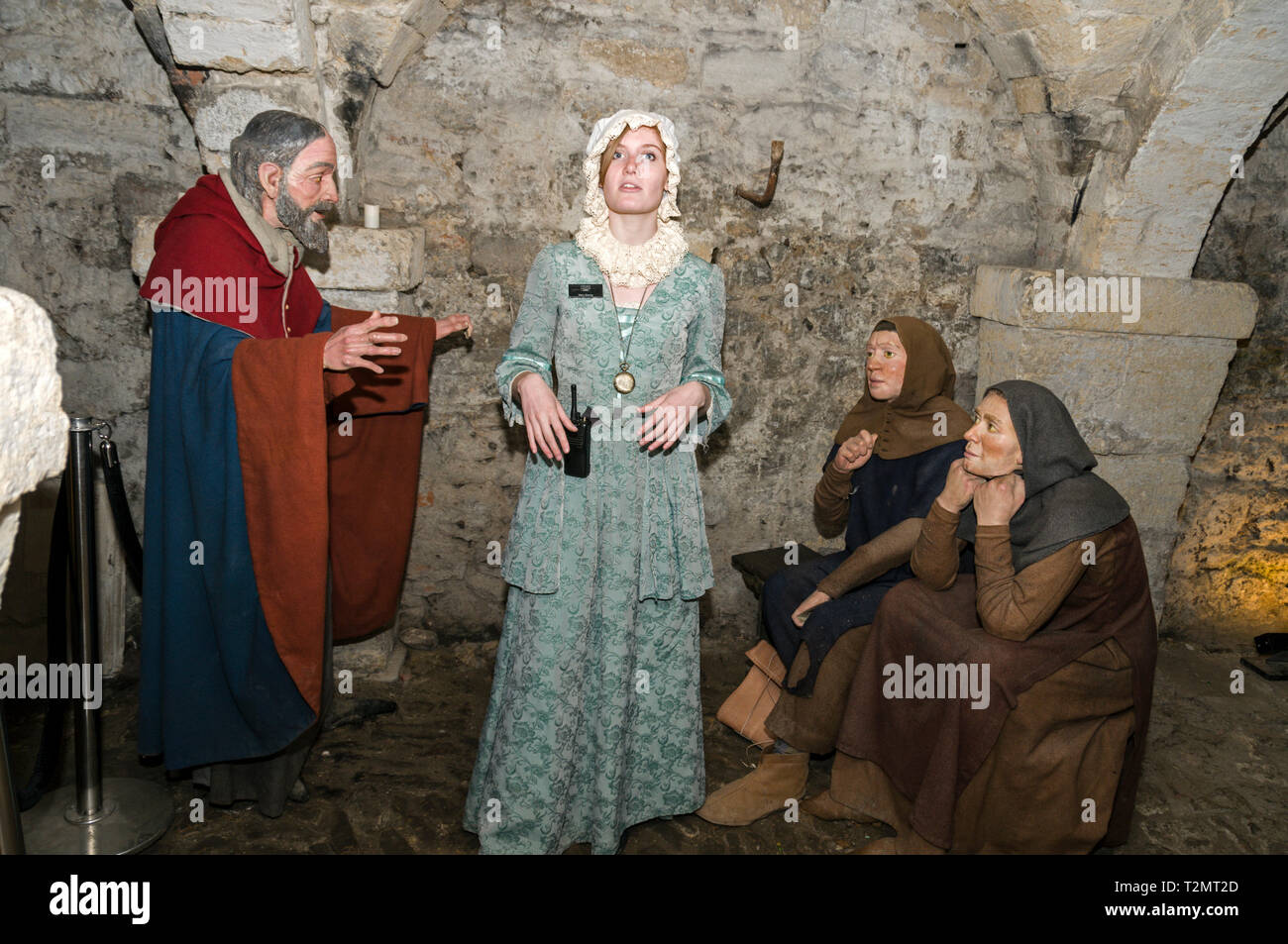 A tour guide dressed as a female prisoner, Mary Bandy in the 900 year old underground crypt at Oxford Castle & Prison in Oxford, Britain.   The guide  Stock Photo