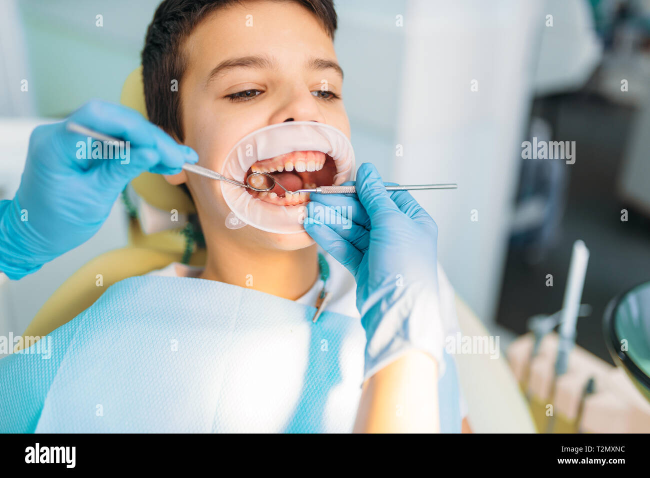 Little Boy With Open Mouth In A Dental Cabinet Caries Removal Procedure Pediatric Dentistry Female Dentist Looking For Caries Stock Photo Alamy