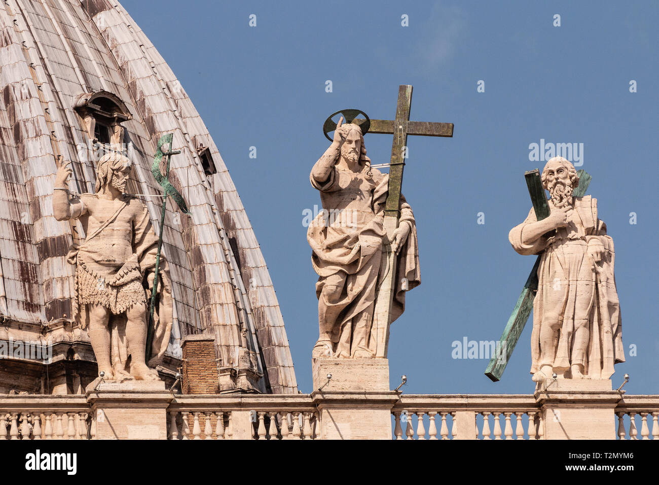 Three on top of St Peter's Basilica. from the left, St John the Baptist, Jesus and the apostle Peter, legendary first Bishop of Rome, and crucified Stock Photo