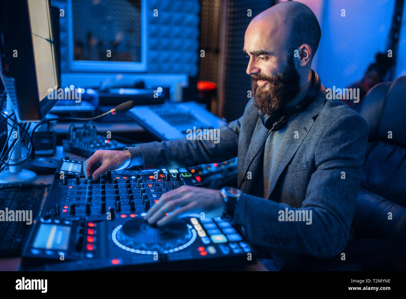 Sound operator at the remote control in the recording studio. Musician