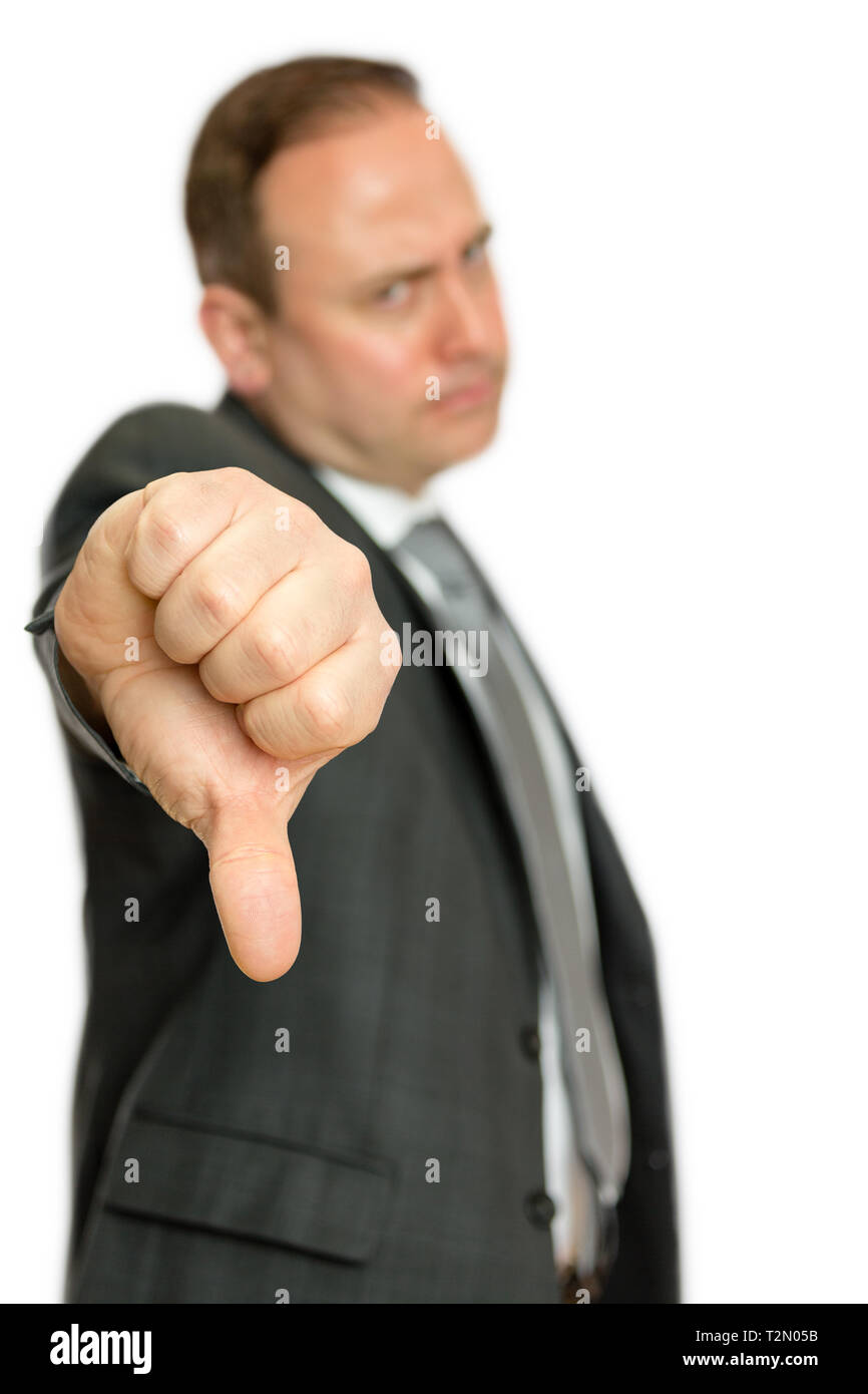 A portrait of an annoyed, angry business man giving a thumbs down signal on a white background with copy space. Stock Photo
