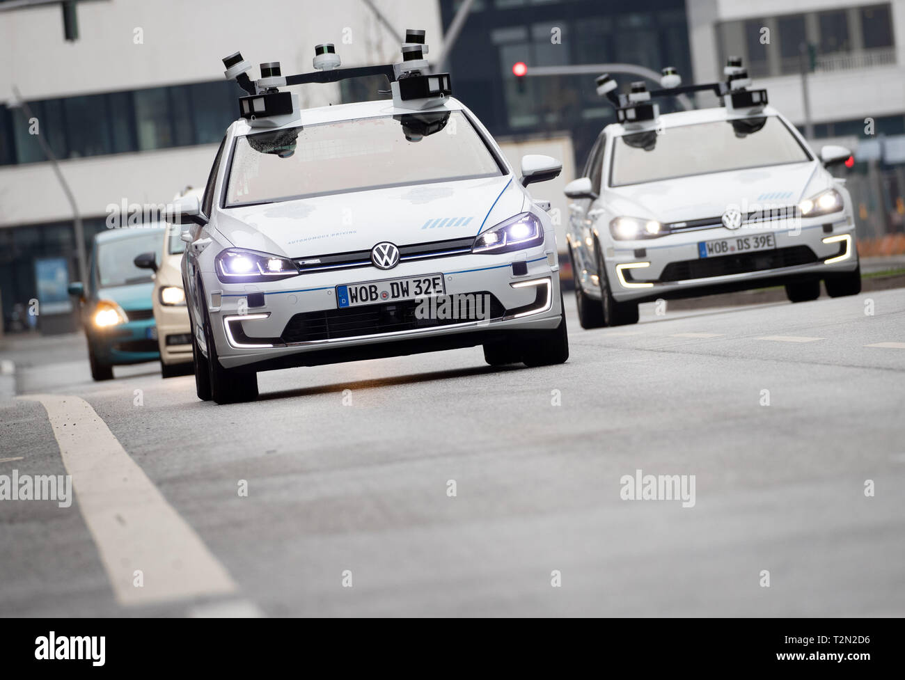 Hamburg, Germany. 03rd Apr, 2019. Two electric Golf cars from Volkswagen,  equipped with laser scanners, cameras, ultrasonic sensors and radar for  fully automatic driving, are on their way to a photo shoot