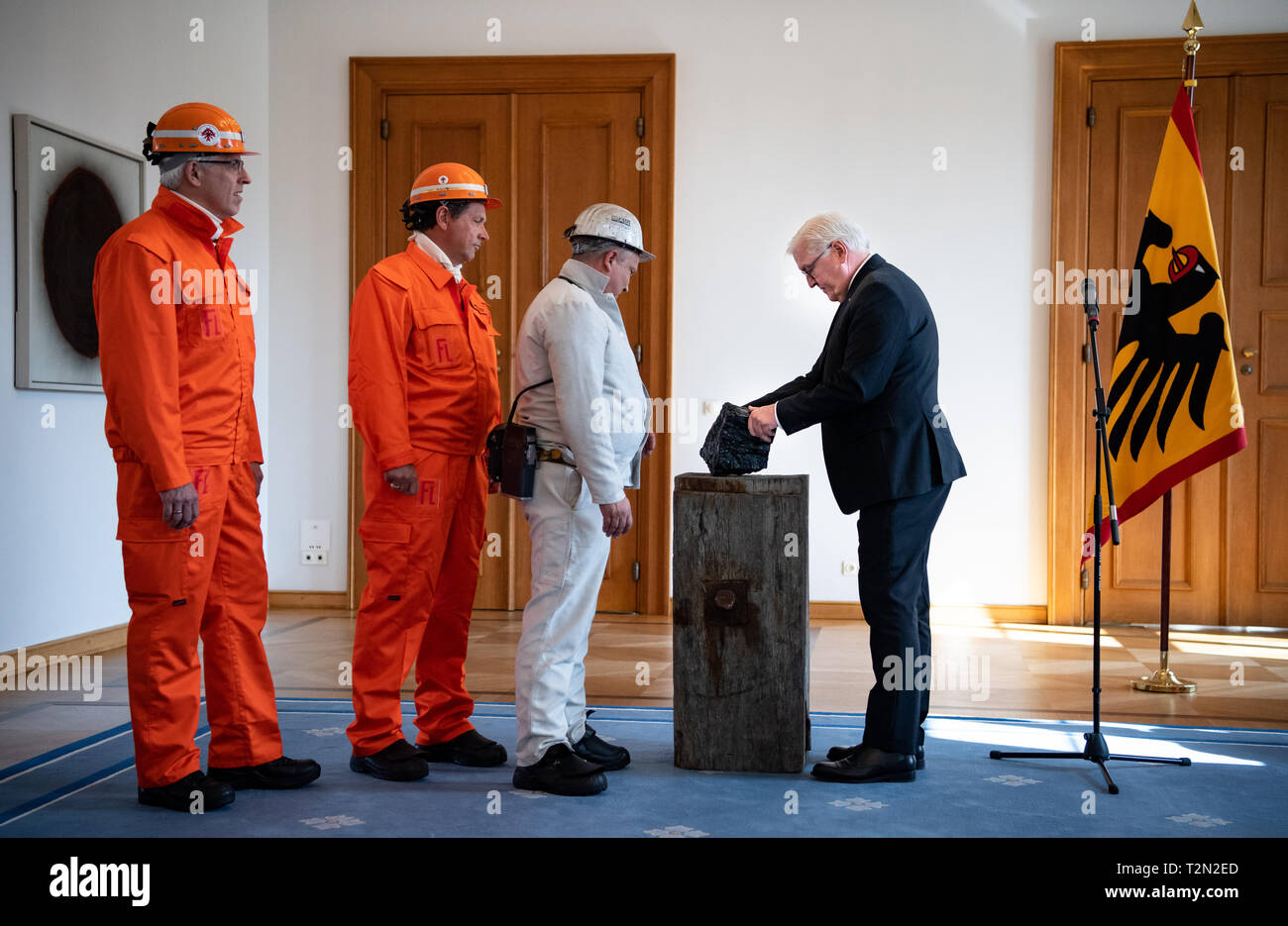 Berlin, Germany. 03rd Apr, 2019. Miners from the RAG mines hand over the last piece of hard coal mined in Germany to Federal President Frank-Walter Steinmeier (r). Steinmeier wants to place the symbolic last piece of coal from Germany in his study at Bellevue Castle. Credit: Bernd von Jutrczenka/dpa/Alamy Live News Stock Photo