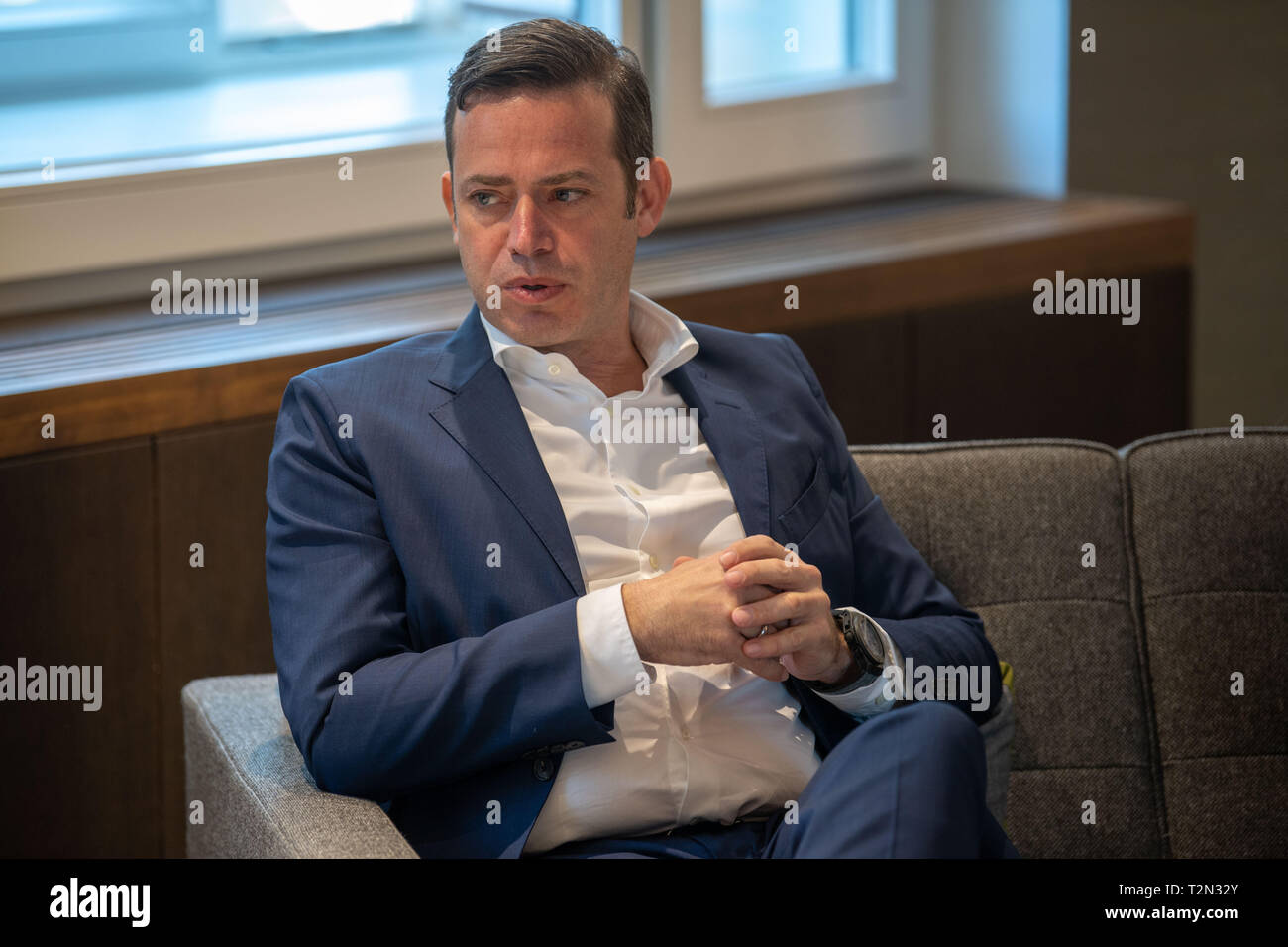 03 April 2019, Bavaria, München: Christian Hirmer, head of the Hirmer Group, sits on the sofa in the Hirmer fashion house during a sit-in. At a press event to present a new image campaign, actor Ferch talked about style and taste. Photo: Lino Mirgeler/dpa Stock Photo