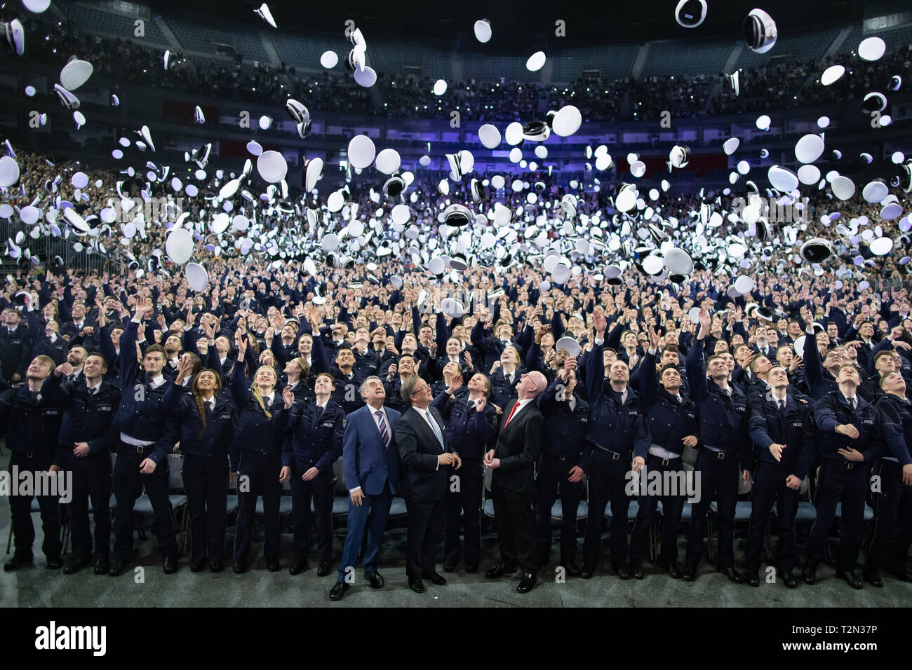 Cologne, Germany. 03rd Apr, 2019. 03 April 2019, North Rhine-Westphalia, Köln: Commissioner candidates throw their caps up after swearing in. 2300 Commissioner candidates of the 2018 police recruitment year have taken their oath of allegiance. Photo: Marcel Kusch/dpa Credit: dpa picture alliance/Alamy Live News Stock Photo