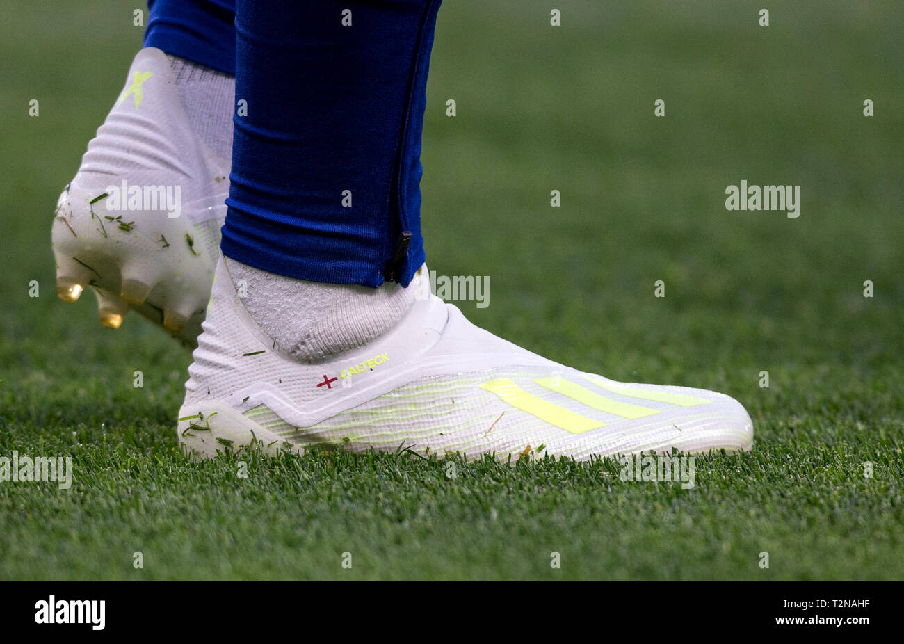 London, UK. 03rd Apr, 2019. The new Adidas X colour football boots of  Callum Hudson-Odoi of Chelsea displaying England flag and CALTECK during  the Premier League match between Chelsea and Brighton and