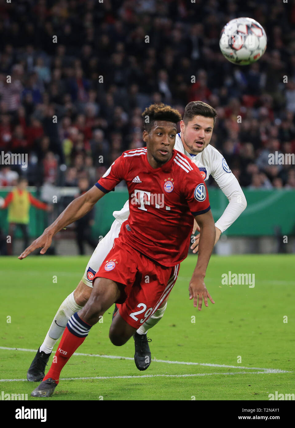 Munich, Germany. 3rd Apr, 2019. Bayern Munich's Kingsley Coman (F) vies with Heidenheim's Marnon Busch during the German Cup quarterfinal match between FC Bayern Munich and 1.FC Heidenheim 1846 in Munich, Germany, on April 3, 2019. Bayern Munich won 5-4 and advanced into the semifinals. Credit: Philippe Ruiz/Xinhua/Alamy Live News Stock Photo