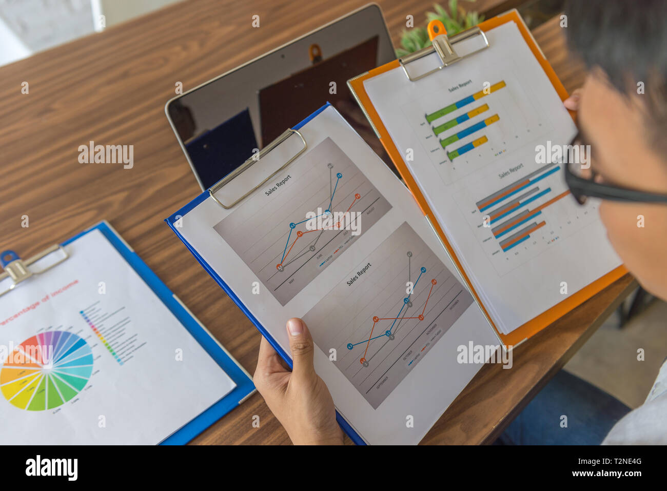 Office employee checking the data on sales reports in office Stock Photo